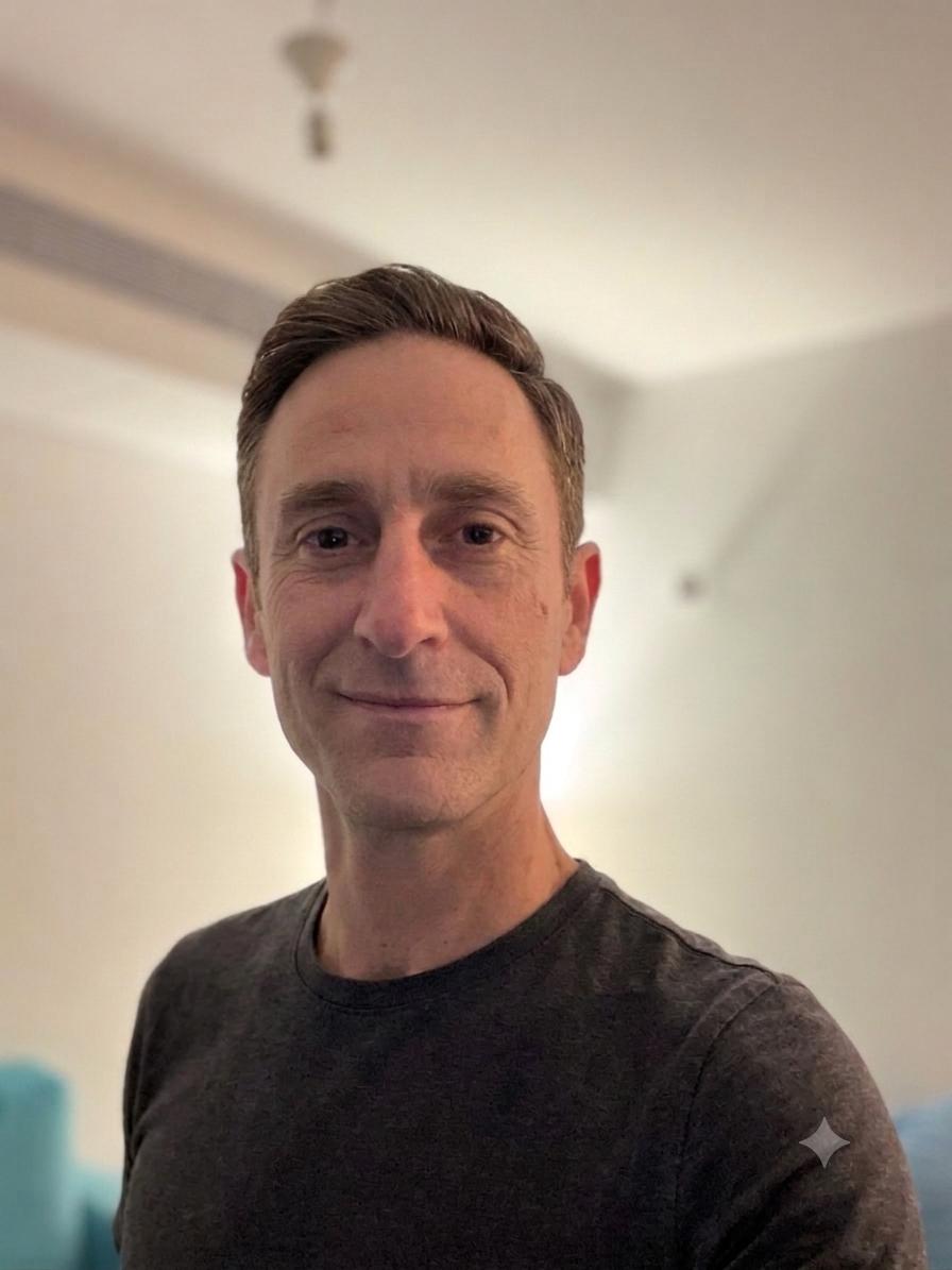 Portrait of Perry Benes smiling at the camera